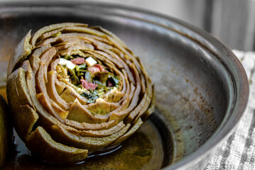 Stuffed artichoke with bacon, parsley and cheese