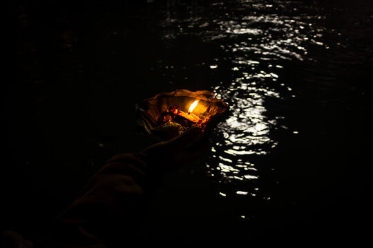 Devotee Holding Aarti Flower Pot For Ganges River Evening Prayer At Night