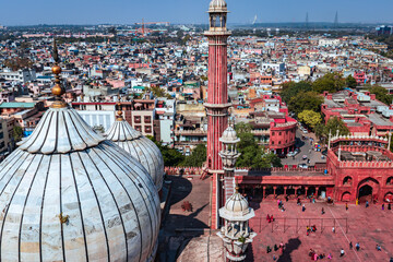 ancient mosque vintage dome and tower with crowded city construction at morning from unique angle