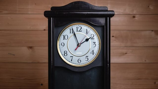 Timelapse of vintage clock with full turn of time hands at 2 am or pm on wooden background. Old Retro wall clock with white circular dial. Old-fashioned antique clock. Arrows second, minute, and hour