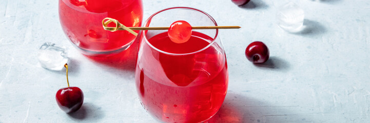 Cocktail with cherry and ice panorama, an aperitif with a garnish and fresh berries, summer drinks...