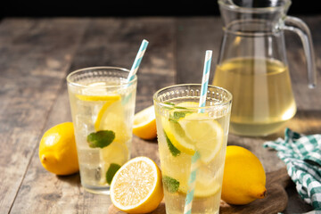 Glass of fresh lemonade on wooden table
