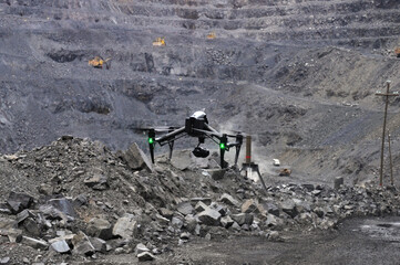 black drone filming in an iron ore quarry