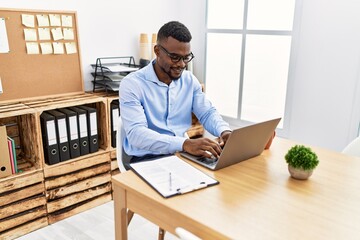 Young african american man smiling confident working at office