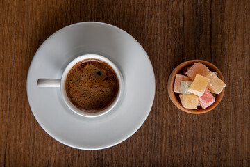 Colorful Turkish delight and Turkish coffee on a wooden background,top view
