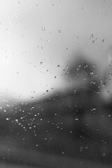 Raindrops on window glass with blur background