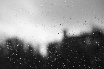 Raindrops on window glass with blur background