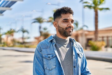 Young hispanic man smiling confident standing at street