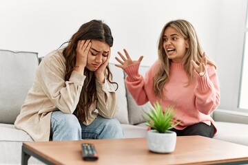 Young couple sitting on the sofa discussing at home.