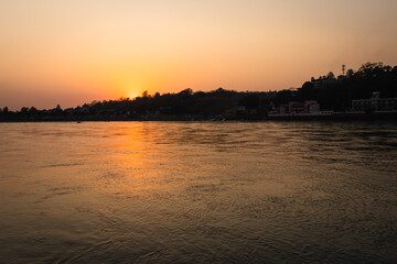 Fototapeta na wymiar sunset dramatic orange sky over river horizon at evening from flat angle