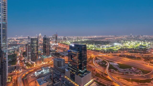 Aerial view of media city and al barsha heights district area day to night timelapse from Dubai marina.