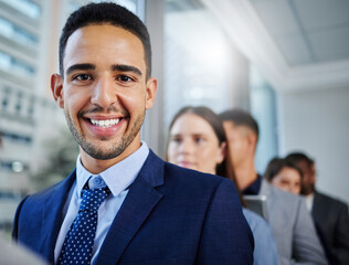 Looking forward to new beginnings. Shot of a young businesswoman standing in line in a modern office.