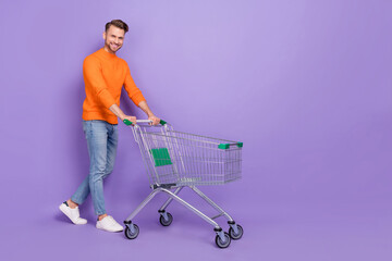 Full body photo of cheerful handsome man go shopping buy products for romantic dinner isolated on...