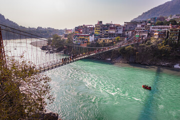 lakshman jhula iron suspension bridge over ganges river from flat angle