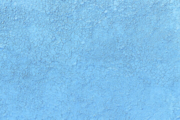 Fototapeta na wymiar Weathered blue painted background with cracks, flat lay. Wall surface with ripped paint texture.