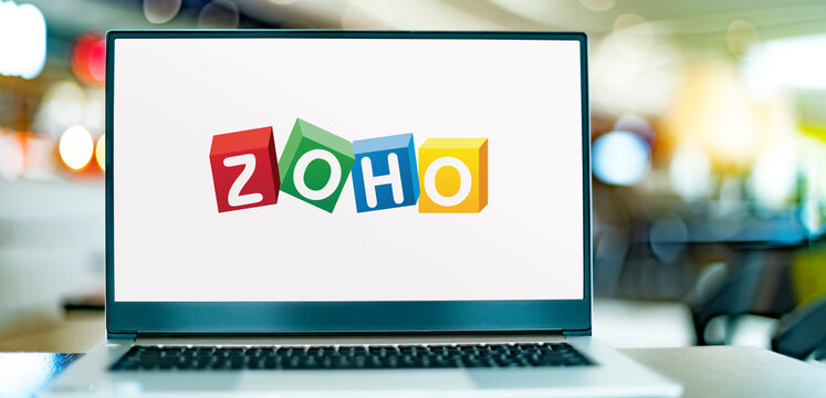 Laptop computer displaying logo of Zoho