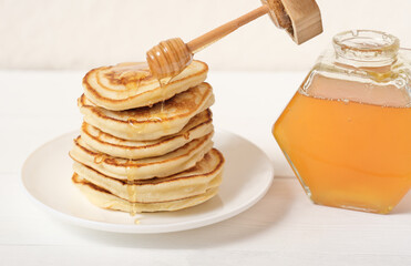 stack of fluffy american pancakes with honey topping. family breakfast or branch recipe. homemade...