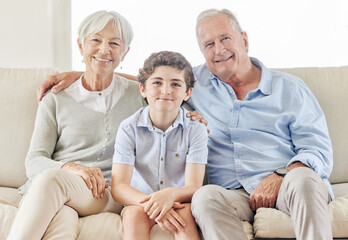 Our best days are together. Shot of a mature couple bonding with their grandson on the sofa at home.