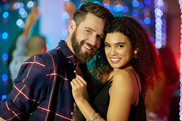 Enjoying a couples night out at the club. Portrait of an affectionate young couple enjoying the evening in a nightclub.