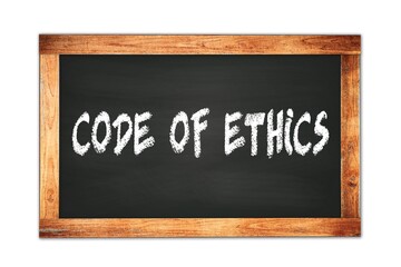 Fototapeta premium CODE OF ETHICS text written on wooden frame school blackboard.