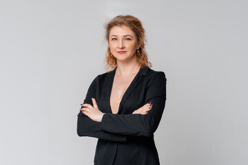 Professional middle age female entrepreneur, real estate agent in suit cross arms and looking confident at camera. Successful businesswoman leading business. Team lead starting meeting