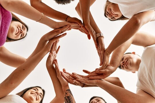 Group of young friends doing circle symbol with hands together