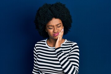 Young african american woman wearing casual clothes touching mouth with hand with painful expression because of toothache or dental illness on teeth. dentist