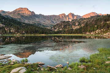 Sunrise at the mountain lake (Lake of Pessons, Andorra)