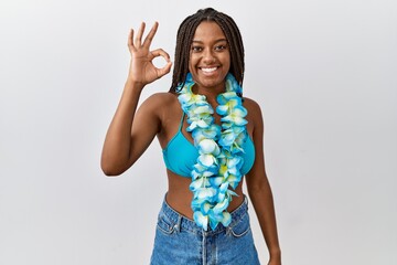 Young african american woman with braids wearing bikini and hawaiian lei smiling positive doing ok...