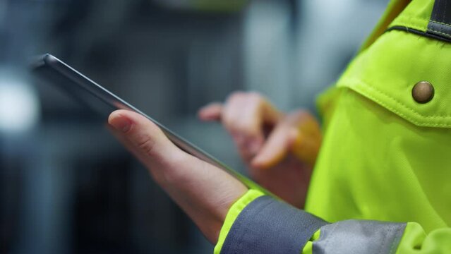 Closeup hands taping tablet computer on manufacturing modern facility factory.