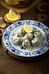 Traditional homemade meatballs with cream, capers and lemon
