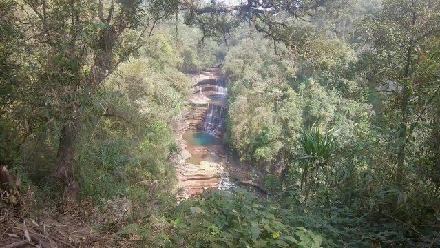 natural three layer waterfall falling from mountain top at forests at day from top angle video is taken at wei sadong waterfall cherrapunji meghalaya india.