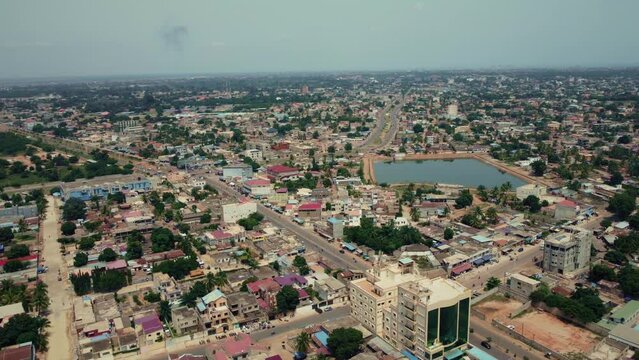Cinematic Circular Motion Aerial View of African City traffic, showing water retention, Lom&eacute;, West Africa