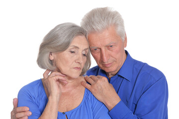 Portrait of sad senior couple on white background