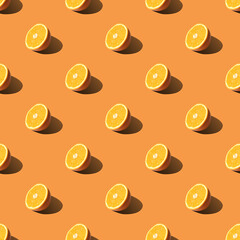 Seamless pattern of half sliced orange on orange background. Minimal, flat lay, food texture.