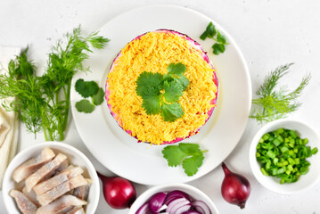 Layered salad with beet, herring, carrots and potatoes.