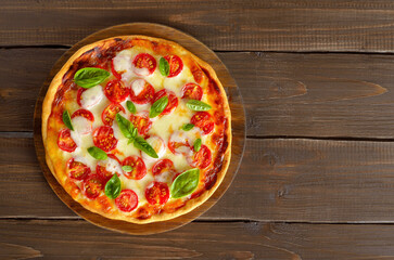Pizza Margarita on a wooden background