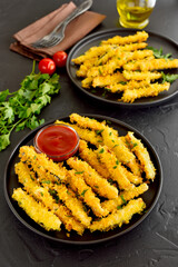 Fried zucchini sticks on plate