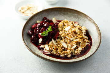 Healthy oatmeal porridge with cherries and almond