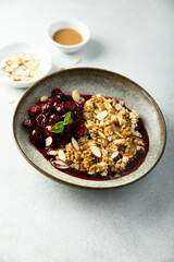 Healthy oatmeal porridge with cherries and almond