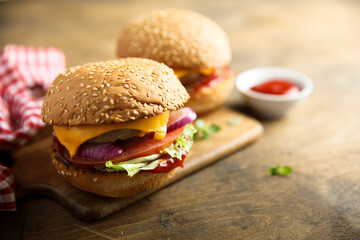 Traditional homemade cheeseburgers with pickles