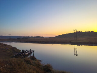 Fototapeta na wymiar calm lake with dramatic sunrise colorful sky reflection at morning