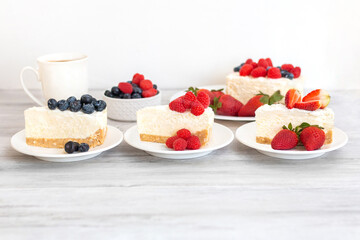 Classic sliced cheesecake with fresh berries - strawberry, raspberries and  blueberries, close up. No baked, Tasty cake with cheese  