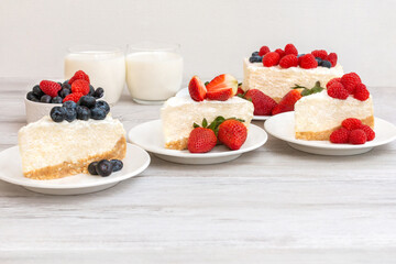 Classic sliced cheesecake with fresh berries - strawberry, raspberries and  blueberries, close up. No baked, Tasty cake with cheese  