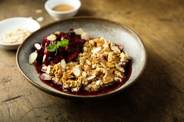 Healthy oatmeal porridge with cherries and almond