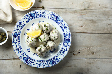 Traditional homemade meatballs with cream, capers and lemon