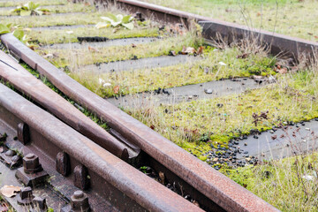 Old abandoned railroad tracks with wooden sleepers