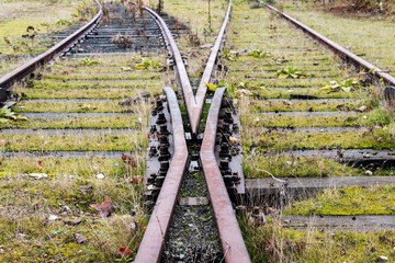 Old abandoned railroad switch with wooden sleepers