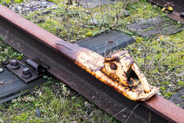 Old train tracks with rusty derailer