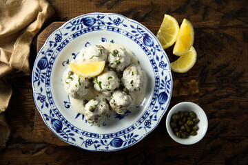 Traditional homemade meatballs with cream, capers and lemon